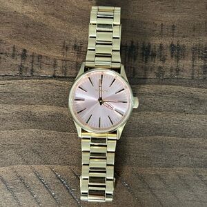 Gently used women’s Nixon The Sentry 38 SS watch with pink and gold face